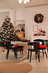 Cozy dining room interior with Christmas tree and festive decor