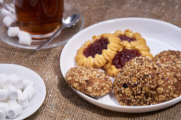 cup of tea and some cookies on white background selective focus