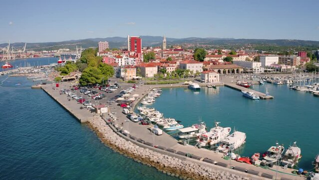 4k drone flight moving to the side footage (Ultra High Definition) of Koper port. Colorful summer scene of Adriatic coastline, Slovenia, Europe. Picturesque Mediterranean seascape.