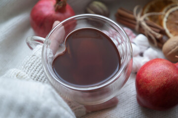 A cup of tea and cookies on a window overlooking the snow - still life, warm winter background.
