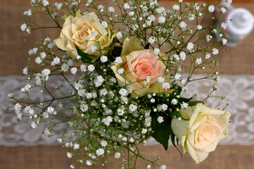 White rose arrangement placed in an authentic antique tea cup as table arrangement to decorate the table for Bridal pamper day Shower  