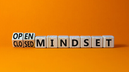 Open or closed mindset symbol. Turned wooden cubes and changed concept words closed mindset to open mindset. Beautiful orange background, copy space. Business open or closed mindset concept.