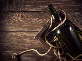 Dark green whisky bottle on a wooden background