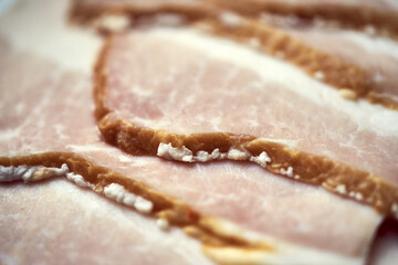 Thin slices of fresh smoked pork bacon