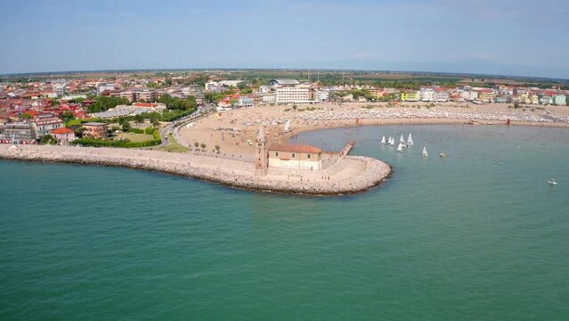4k drone forward video (Ultra High Definition) of Madonna dell'Angelo church - small seaside chapel, built in 1751 and dedicated to the Virgin Mary, Caorle town, Italy, Europe.