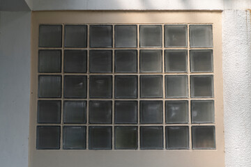 Close up of glass blocks wall allowing light to enter building interior.