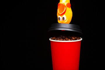 image of coffee cup rubber chicken dark background