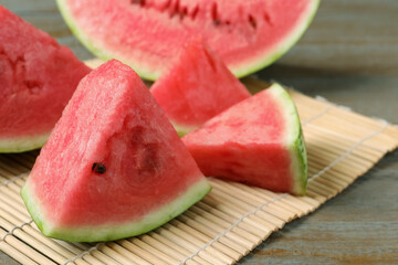 Slices of tasty ripe watermelon on wooden table, closeup