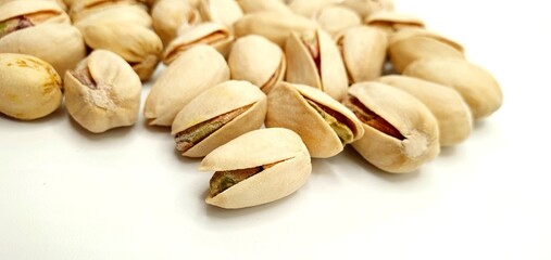 Pistachio nuts isolated. Delicious pistachio nuts on a white background. Salted nuts.	