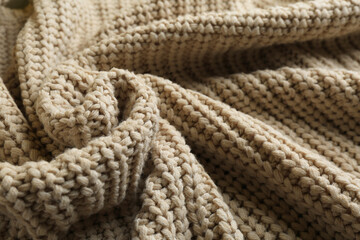 Fototapeta na wymiar Beautiful beige knitted fabric as background, closeup