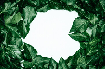 Fototapeta premium Creative layout made of leaves with paper card note. Flat lay. Blank for advertising card or invitation. Nature concept.