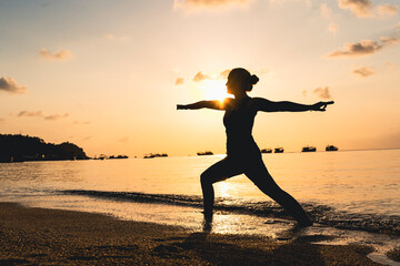 Fototapeta na wymiar Woman doing yoga at the beach.