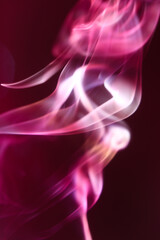 Obraz premium Beautiful red and pink puffs of smoke