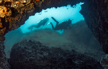 two women exploring underwater cave in Koh Tao / Thailand