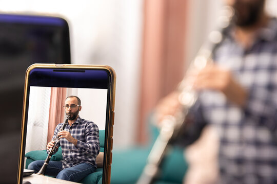 Clarinetist giving online clarinet class with the laptop from ho