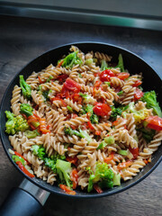 Traditional italian pasta with colorful vegetables in skillet