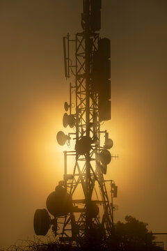 Huge antenna with strong back sunlight on a foggy day
