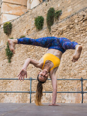 Fit woman practising capoeira tricks