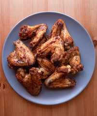 grilled chicken wings on a grey plate.