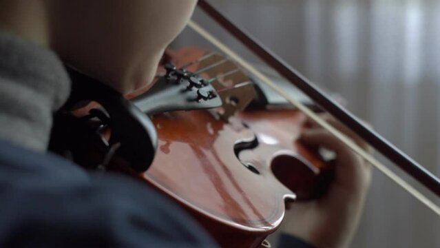 Playing the violin. Little boy learning to play the violin 