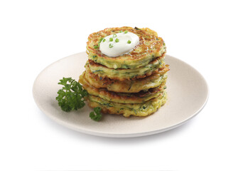 Delicious zucchini fritters with sour cream isolated on white