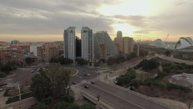 Flying over Valencia at sunset, Spain. Cityscape with bridge and buildings