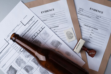 Fingerprint card, mesh bottle on the background of evidence packaging and stamp