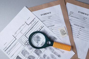 Fingerprint card, magnifying glass on  background of evidence packaging
