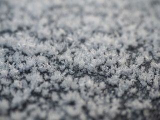 Snowflakes, snow crystals on the car roof. Freeze, frost, macro