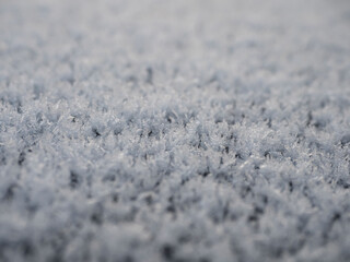 Snowflakes, snow crystals on the car roof. Freeze, frost, macro