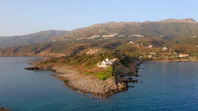4k drone flight back footage (Ultra High Definition) of Agia Paraskevi Church. Breathtaking evening scene of Peloponnese peninsula, Greece, Europe. Beautiful summer seascape of Ionian sea.