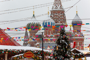 Moscow, Russia, February 7, 2022, Red Square in the morning during a winter snowfall, view of St. Basil's Cathedral and fairs.