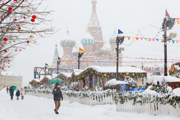 Moscow, Russia, February 7, 2022, Red Square during a winter snowfall, view of St. Basil's Cathedral in winter. Image of Russian winter in white light. Walking in the center of Moscow, it's snowing
