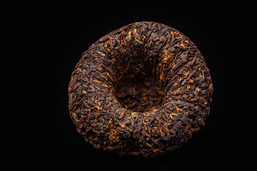 nest chinese puer tea on dark background close-up
