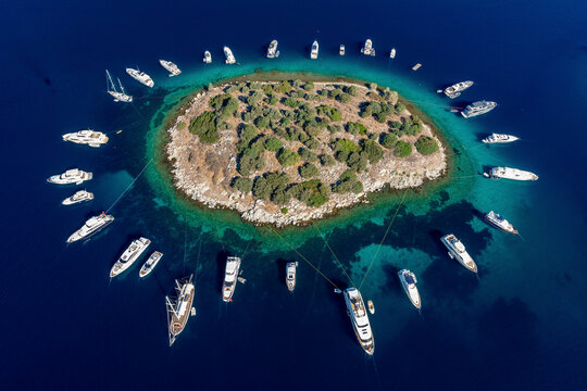 Aerial view of anchored boats around an island in Turkbuku, Bodrum, Turkey.