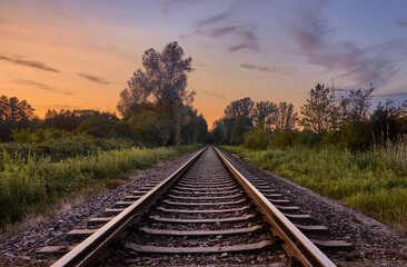 Fototapeta premium Empty train track at sunset in countryside