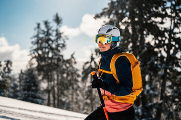 Mountaineer backcountry ski walking ski woman alpinist in the mountains. Ski touring in alpine...
