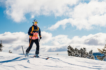 Mountaineer backcountry ski walking ski woman alpinist in the mountains. Ski touring in alpine...