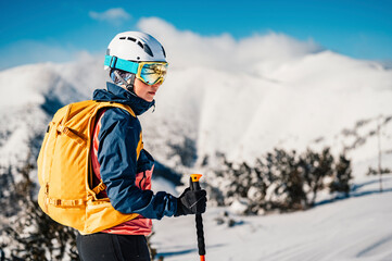 Mountaineer backcountry ski walking ski woman alpinist in the mountains. Ski touring in alpine...