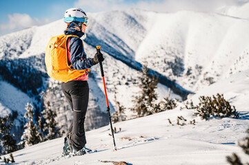 Mountaineer backcountry ski walking ski woman alpinist in the mountains. Ski touring in alpine...
