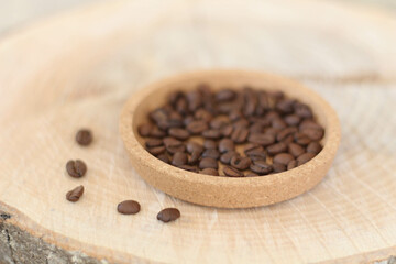 Cafe concept. Coffee beans on natural wooden table and background, trendy design background concept. Coffee business