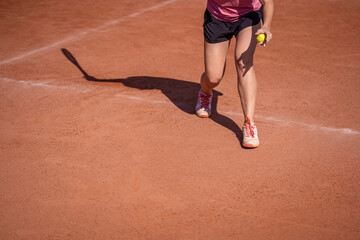 shadow woman tennis player on an outdoor clay court