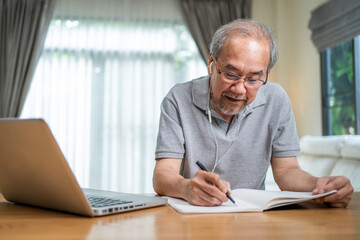 Fototapeta na wymiar Asian Senior elderly business man working online with laptop computer. 