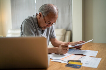 Depressed Asian senior elder man feel worried about financial problem. 