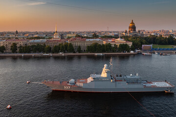 Aerial morning urban landscape with warships in the waters of the Neva River before the holiday of...