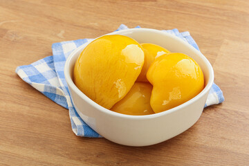 Sweet canned peaches with syrope