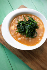 White beans with spinach. Legumes and vegetables. Healthy dish with vegan protein. Plant based food.