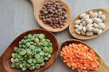beans and lentils on wooden spoons
