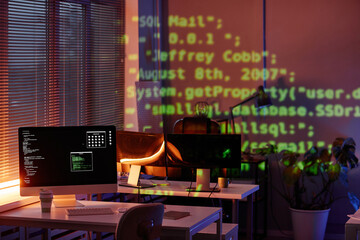 Computer monitor with decoded data on screen standing on desk in modern office or bureau of...