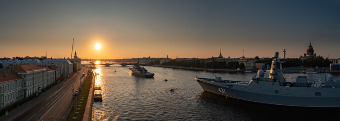 Aerial panoramic landscape of warships in the waters of the Neva River before the holiday of the Russian Navy, sea power, the latest cruisers among the sights, Isaac cathedral on a background